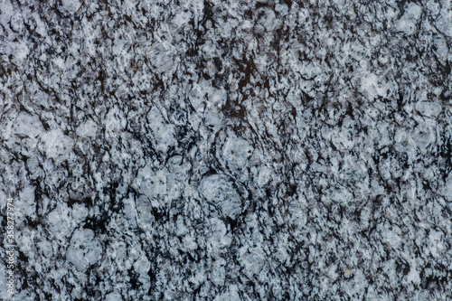 Granite wall dark texture. Grey natural stone background © dmf87