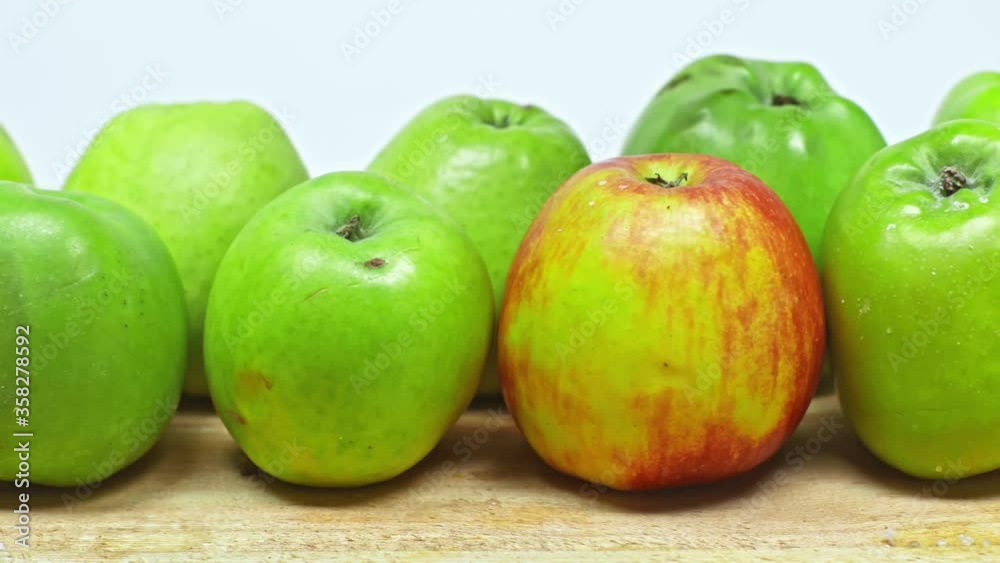 Cropped view of man taking apple on wooden surface isolated on white Cropped view of man taking apple on wooden surface isolated on white