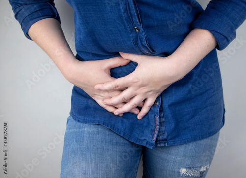A woman suffers from pain in the appendix. Acute appendicitis, Crohn's disease, or inflammatory bowel disease. Surgeon examination and preparation for laparoscopic appendectomy
