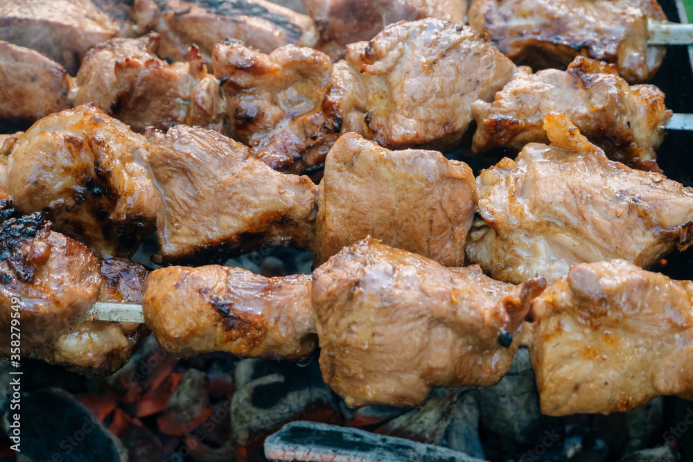 barbecue pork meat on skewers on fire on the grill barbecue pork meat on skewers on fire on the grill