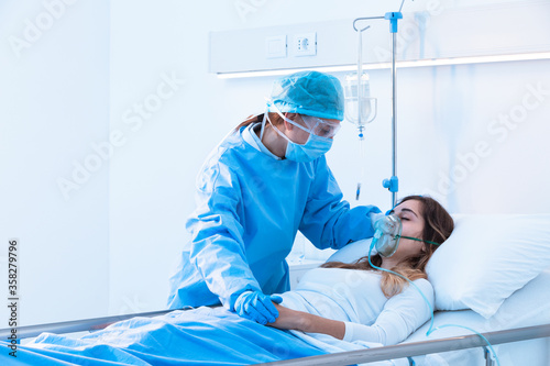 Nurse comforting a sick patient in the ward