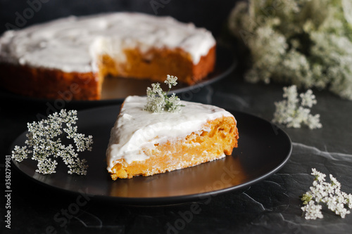Tasty carrot cake with cottage cheese. Pie on the table. Cake with flowers