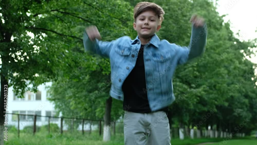 Little boy takes off his medical mask outdoors. The child is happy to end the quarantine, coronavirus, covid19, self-isolation. Little boy takes off his medical mask outdoors. The child is happy to end the quarantine, coronavirus, covid19, self-isolation.