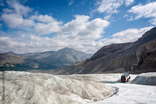 Tourist truck epxloring Athabasca glacier in Columbia Icefield, Jasper National park,  Rocky Mountains, Alberta, Canada photo
