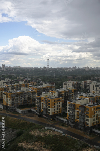 Apartment buildings on a background of beautiful clouds. High-rise buildings are built with panel construction in which people live. Stock photo background