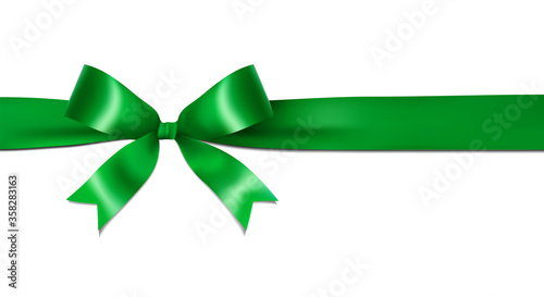 Shiny green ribbon bow isolated on white background with copy space. For using special days.