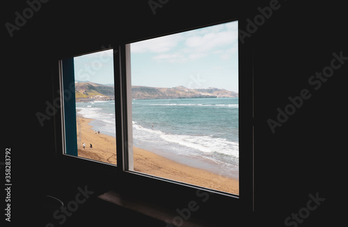 window with views of beach and sea