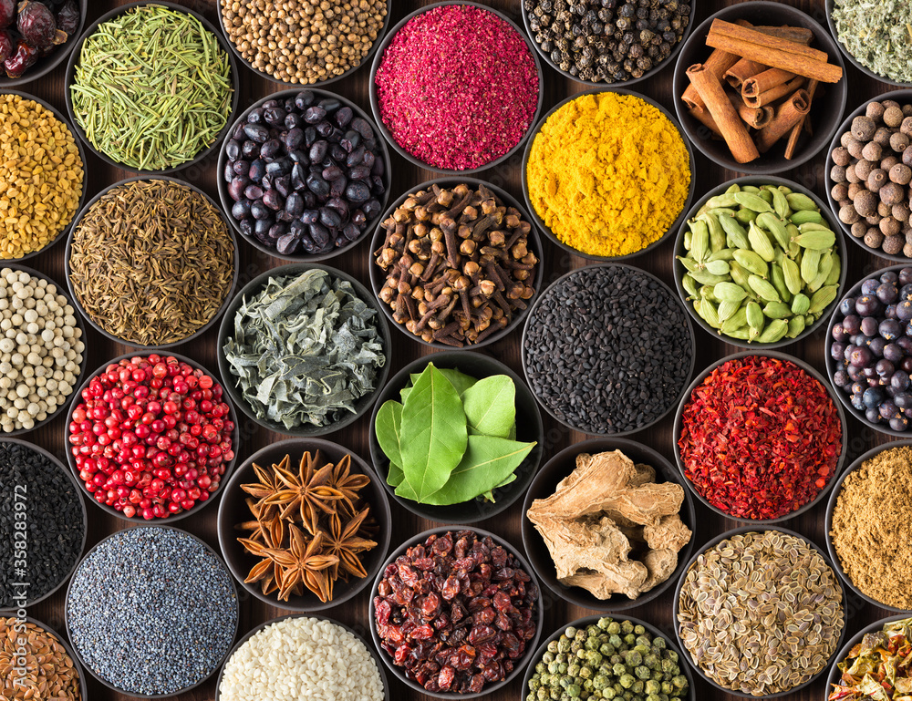 bright Indian spices and herbs in cups, top view. background for packing with condiments. - obrazy, fototapety, plakaty 