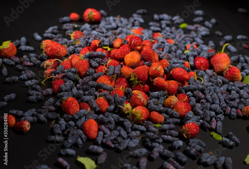 many berries on the table. Strawberry