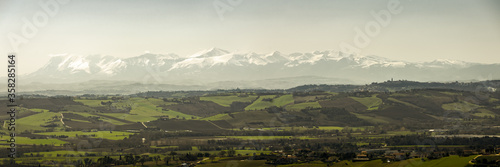 Panorama of the entire mountain range of the Sibillini Mountains (Marche region) from Recanati, partially covered by snow. photo