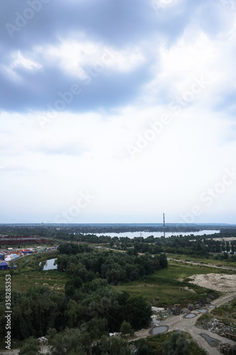 Outskirts of the city industrial zone on the background of a river or lake. Stock photo for design