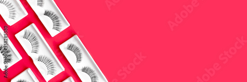 Foto Different fake eyelashes on a trendy bright red background
