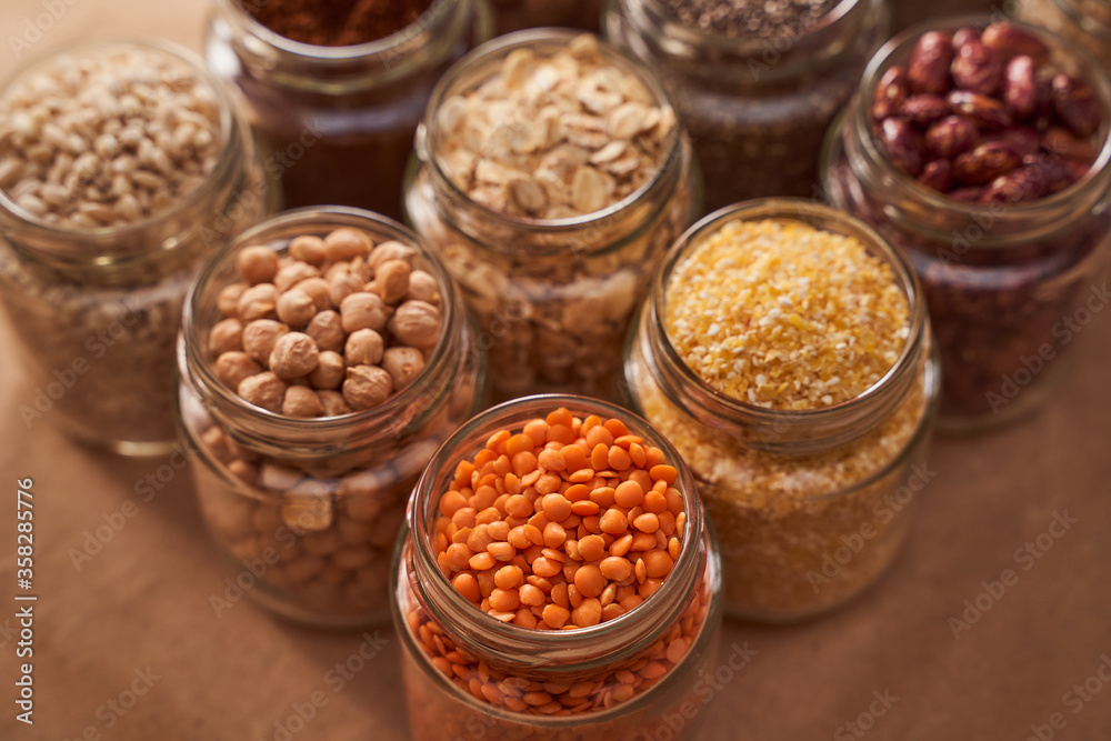 Super food grits in glass jars. Top view. lentils, chickpeas, corn, oats, beans, chia Super food grits in glass jars. Top view. lentils, chickpeas, corn, oats, beans, chia