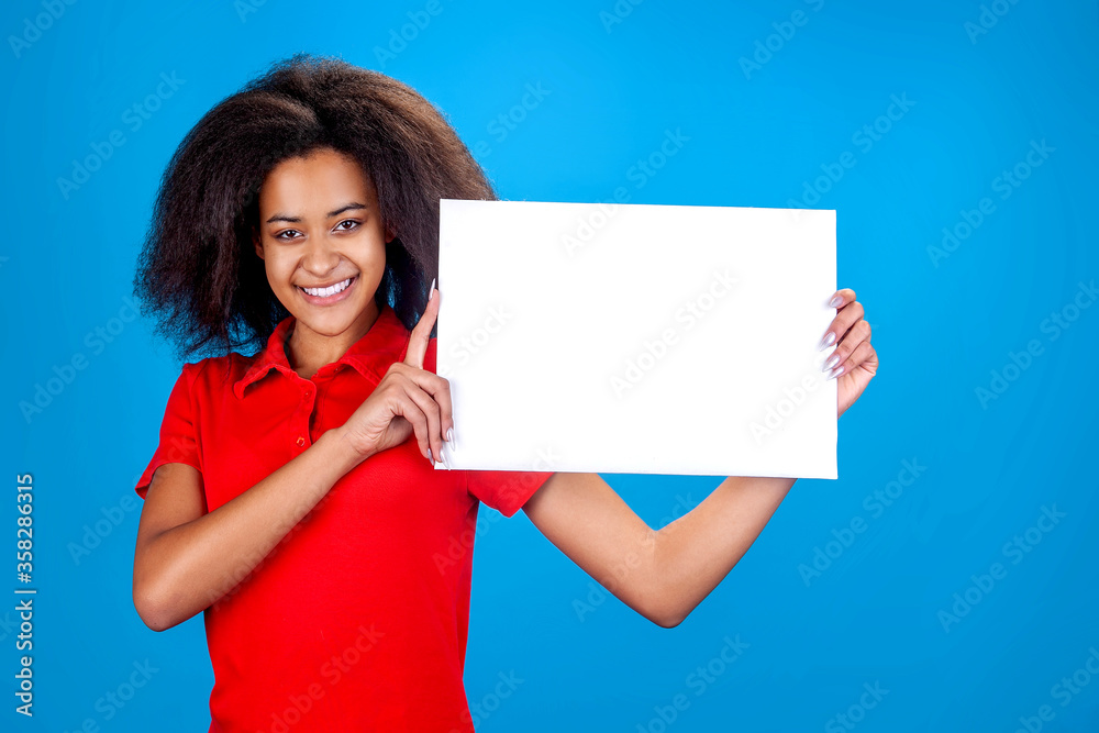 dark-skinned smiling woman holds a white background for an inscription dark-skinned smiling woman holds a white background for an inscription