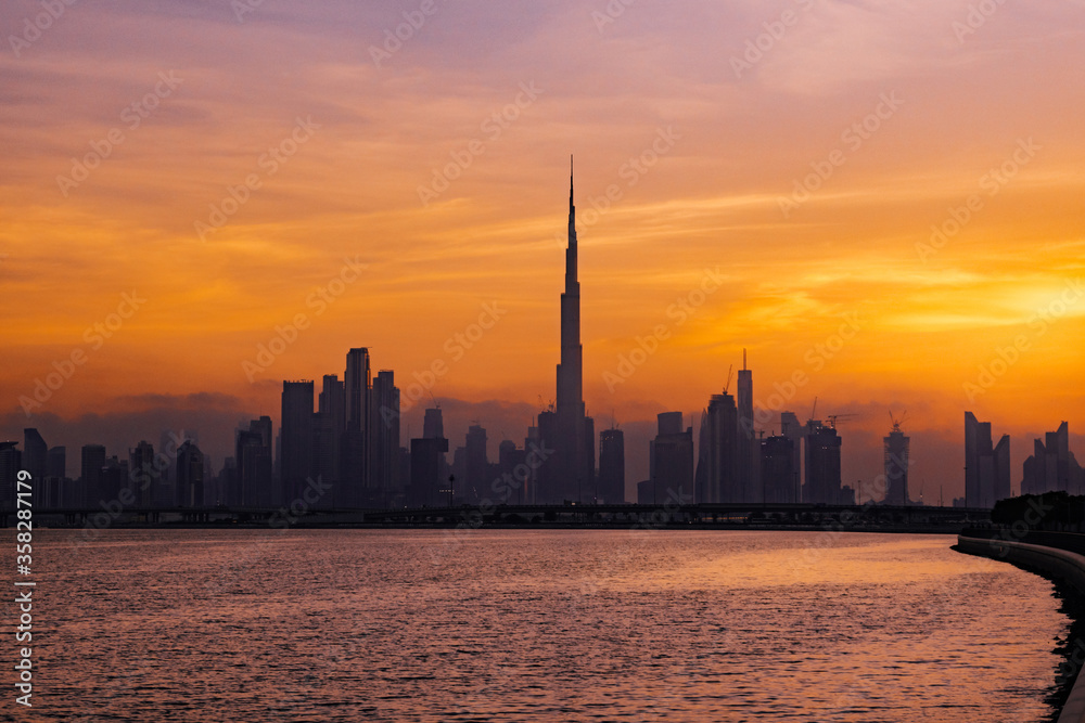 Beautiful view of Dubai Skyline during a fiery golden hour. Travel, Holiday concept. 