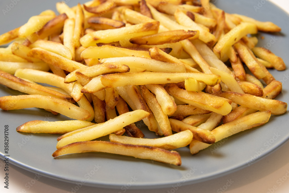 French fries on a blue plate. Close up view French fries on a blue plate. Close up view