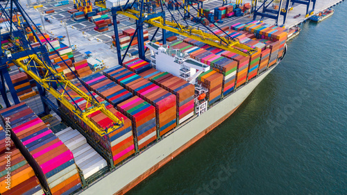 Container ship unloading in deep sea port, Global business logistic import export freight shipping transportation oversea worldwide container ship, Container vessel loading cargo cargo freight ship.