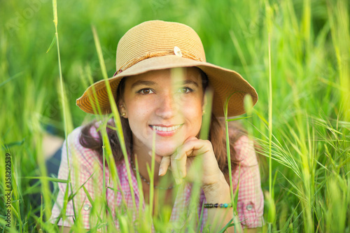 Young pretty woman sitting in the grass portrait