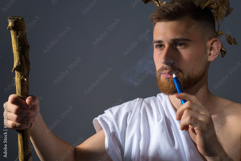 Fotografie a bearded god smokes an electronic cigarette