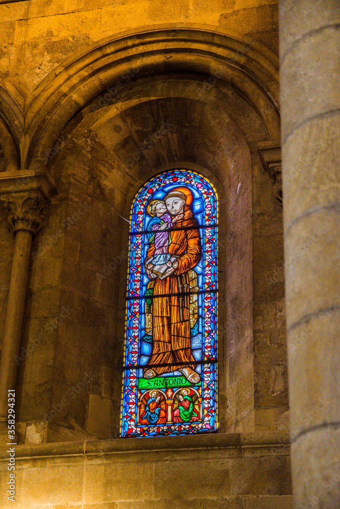 stained glass window with the image of a saint in the church