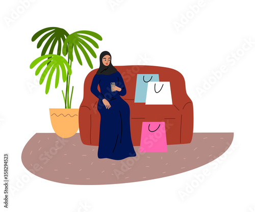 Muslim girl sitting on the sofa with shopping bags and holding the phone. Vector illustration in flat cartoon style