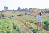 young happy european model / summer vacation, a walk in nature in the summer landscape, an adult girl alone