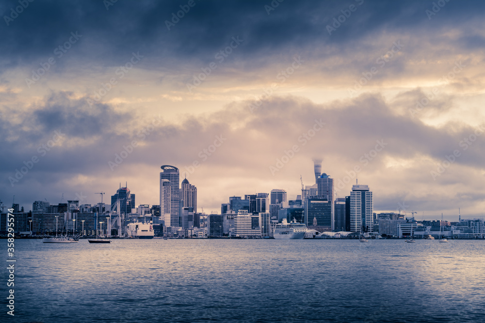 Retro-style photo of Auckland City downtown skyline at sunset.