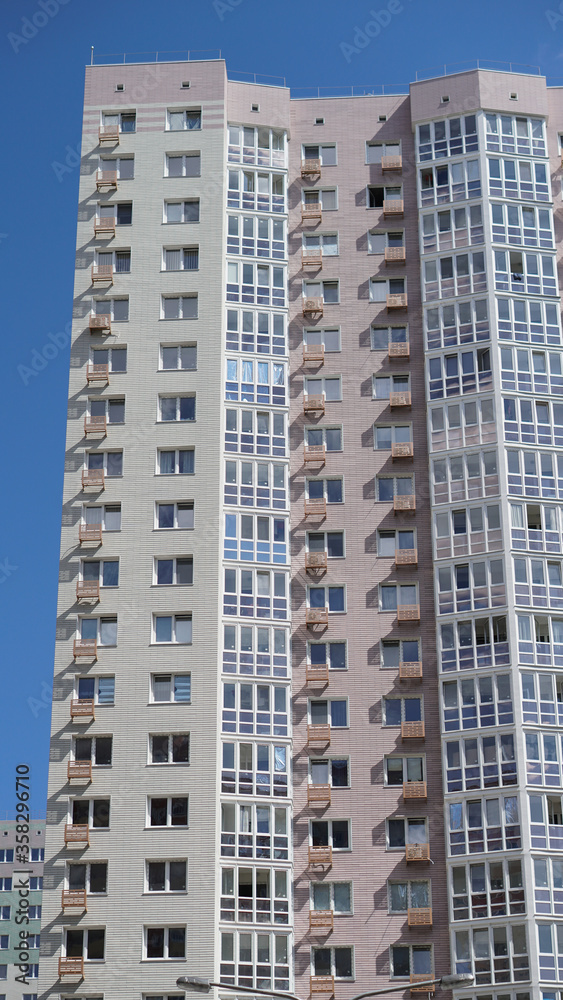 Large construction site on a background of blue sky. Brick, panel apartment building. Industrial theme for design