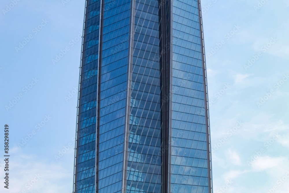 Fragment of the facade of the office building against the blue sky. Fragment of the facade of the office building against the blue sky.