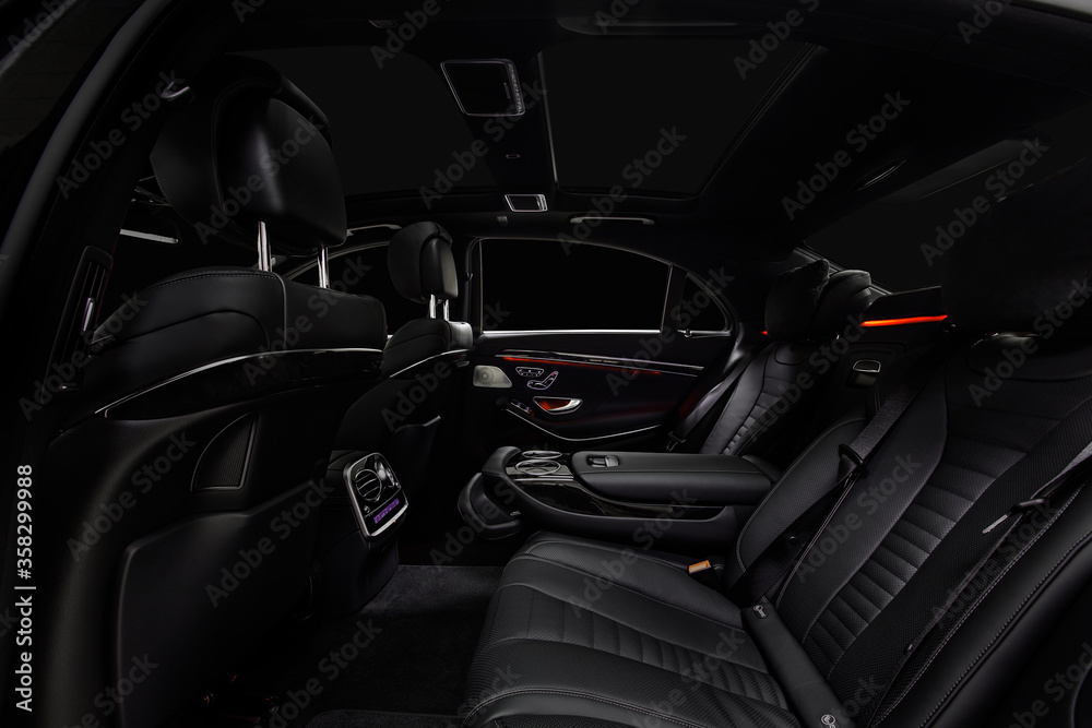 Comfortable interior of prestige modern car. Back leather seats with  ambient light.