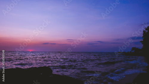 Purple twilight sky over calm ocean horizon at dusk photography