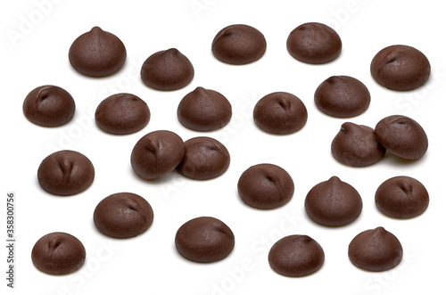 Chocolate chips morsels close up from top view isolated on white background. 