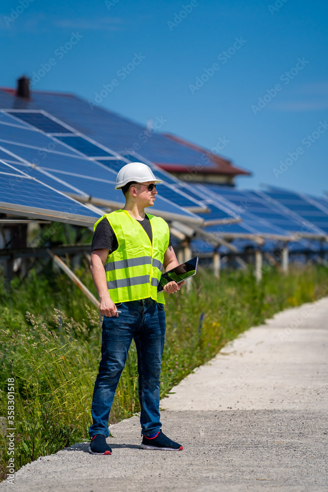 Engineer discussing installing solar panels at solar energy plant.