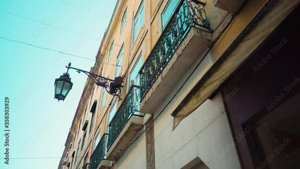 Lisbon empty downtown streets with balcony facade, ancient lamps at sunrise during covid pandemi Lisbon empty downtown streets with balcony facade, ancient lamps at sunrise during covid pandemi
