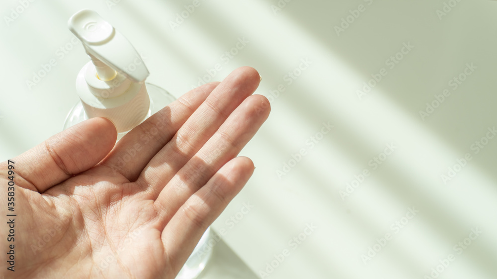 A female hands waiting for hand sanitizer alcohol gel pump dispenser with copy space. Pandemic protection concept. Dispenser infection control concept. A female hands waiting for hand sanitizer alcohol gel pump dispenser with copy space. Pandemic protection concept. Dispenser infection control concept.