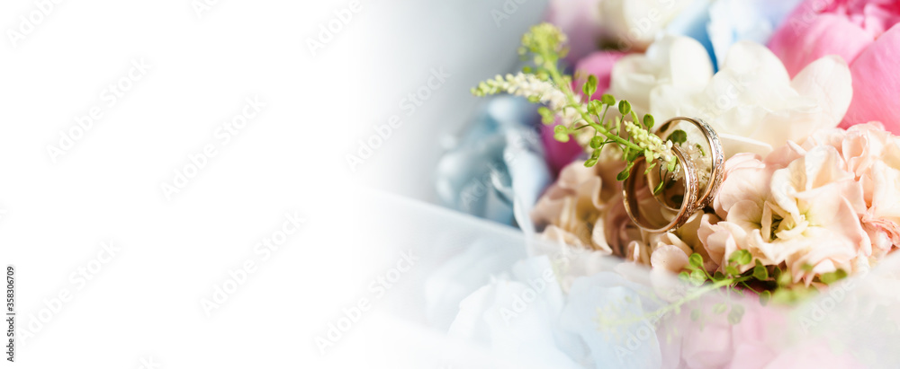 Fototapeta premium Elegant wedding accessories of an attractive bride. Wedding rings, shoes, bridal bouquet, floral arrangements, veil. Copy space for text. Background for greeting card or invitation.