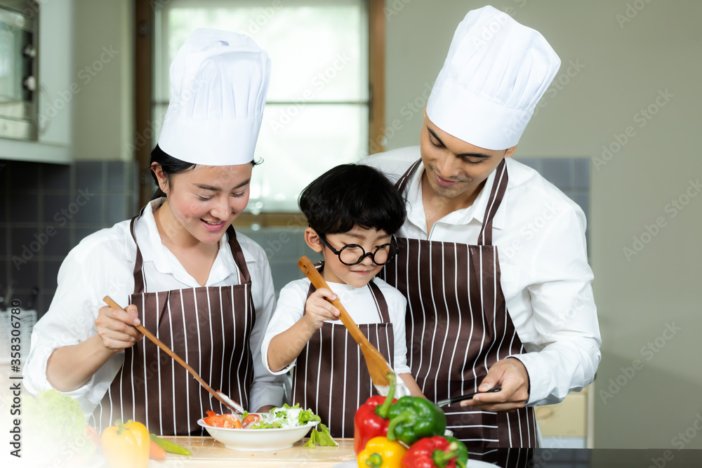 Cooking Family. Chef parent and kid boy make fresh vegetables salad for healthy eat. Cooking Family. Chef parent and kid boy make fresh vegetables salad for healthy eat.