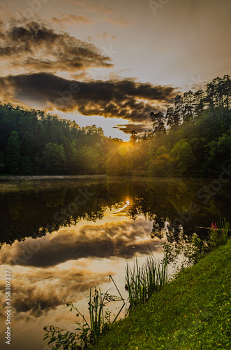 Fototapeta Naklejka Na Ścianę i Meble -  Scenic sunset over the lake and forest