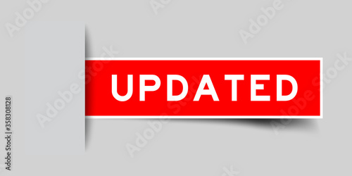 Inserted red color sticker label with word updated on gray background