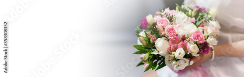 Wedding bouquet in hands of elegant bride. Copyspace with white space for text. Wedding accessories and backgrounds