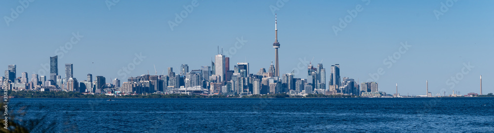 A panoramic view of Toronto, Ontario, Canada, and Lake Ontario, on a summer day with blue and clear sky

