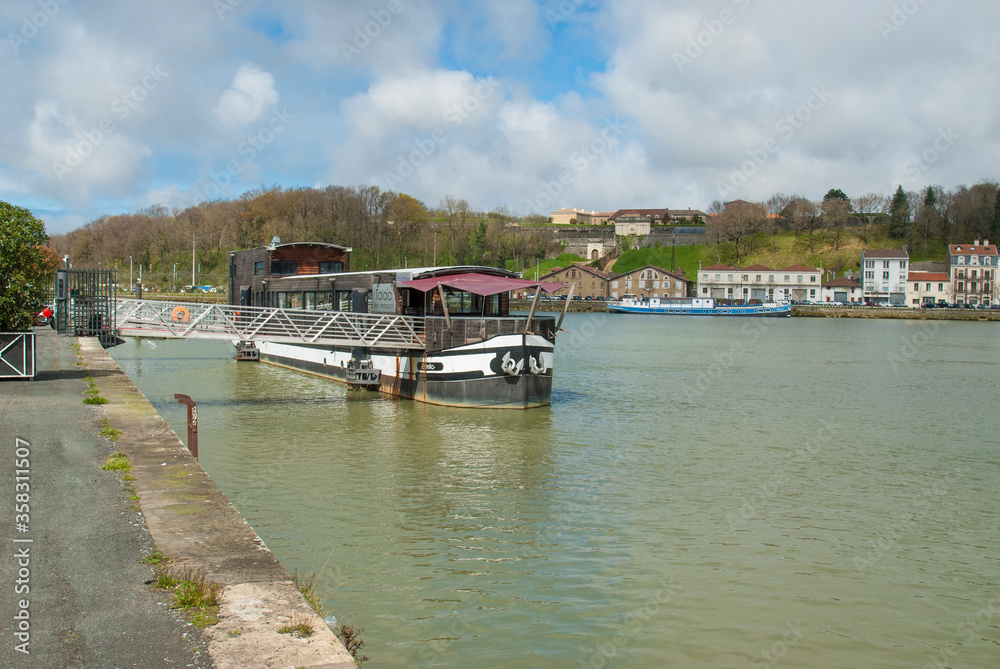 Adour river with a barge as it passes through Bayonne Adour river with a barge as it passes through Bayonne