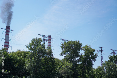 Pipe of the plant with which there is smoke against the sky. Factory and environmental topics of environmental pollution. Stock background for design.