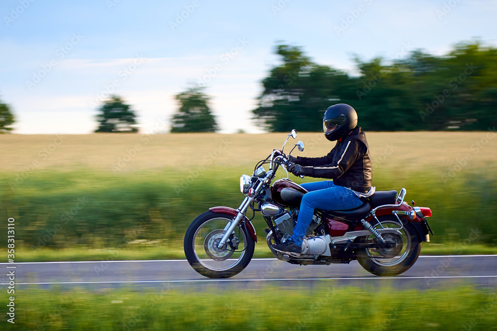 Unidentified man driving a chopper motorcycle