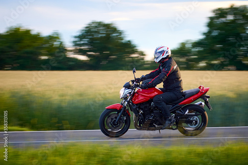 Fototapeta Naklejka Na Ścianę i Meble -  Unidentified man driving a motorcycle