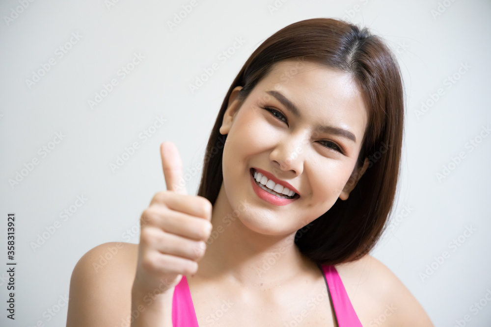 successful girl pointing thumb up; portrait of cheerful smiling woman pointing up approving, yes, ok, good, thumb up gesture; southeast asian woman young adult model successful girl pointing thumb up; portrait of cheerful smiling woman pointing up approving, yes, ok, good, thumb up gesture; southeast asian woman young adult model