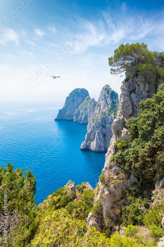 Famous Faraglioni Rocks near Capri Island, Italy. Beautiful paradise image with azure sea in summer sunny day.