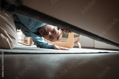 Obraz na plátne Under his bed in bedroom