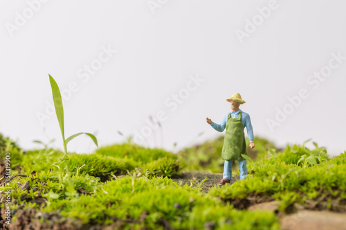 Young man working on green Grass 