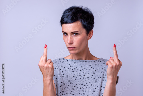 Attractive woman making a middle finger gesture photo